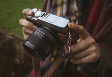 Mid Section Of Woman Holding Digital Camera