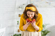 © LIGHTFIELD STUDIOS - beautiful woman sniffing ripe red bell pepper at kitchen