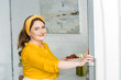© LIGHTFIELD STUDIOS - beautiful woman holding plate with vegetables at kitchen