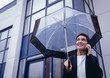 © Wavebreak Media - Businesswoman holding umbrella while talking on mobile phone
