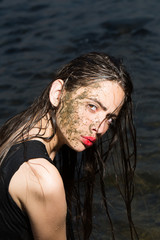 Wall Mural - a close up of a woman's face in mud