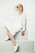 © Raisa Kanareva - Children's fashion. Beautiful pensive serious blonde girl in white clothes. Fashion and people concept.