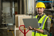 © Wavebreak Media - smiling male worker using laptop in distribution warehouse