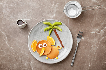 Flat lay composition with pancakes in form of elephant on grey background. Creative breakfast ideas for kids