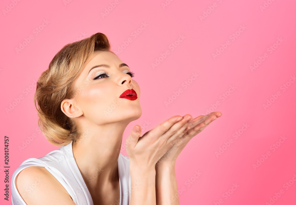Skincare, haircare, beauty concept - woman with perfect skin, red lips blowing kiss from hand. Beautiful girl showing empty copy space on open hand palm for text. Copy space for advertise beauty salon - obrazy, fototapety, plakaty 