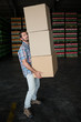 © Wavebreak Media - Man carrying cardboard boxes in warehouse