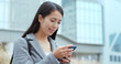 © leungchopan - Business woman use of mobile phone