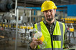 © Wavebreak Media - Confident male worker inspecting bottles in juice factory