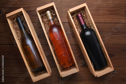 Fotografie, Obraz Cabernet and Chardonnay wine bottles in individual cases