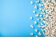 Popcorn scattered on blue background. Copy space for text