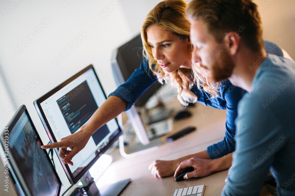 Software engineers working on project and programming in company Stock ...