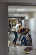 schoolboy being bullied in school corridor with blurred frightened schoolgirls on background