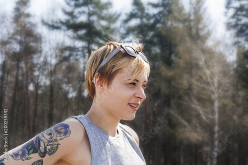 Natural Looking Woman With Blonde Short Hair And Tattoo Wearing