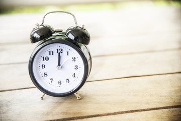 Wall Mural - Vintage clock on wood table.