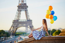 Young Woman With Bunch Of Balloons Near The Eiffel Tower