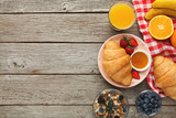 Fototapeta Mapy - Fresh crusty croissants and orange juice for morning meals