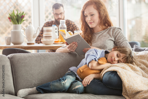 Son lying on mother's laps Poster Mural XXL