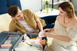 happy pregnant woman and husband preparing suitcase for hospital