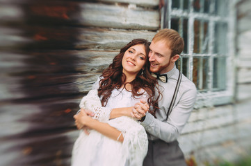 Wall Mural - Bride and groom hugging in a forest near the horse in the autumn forest, wedding walk