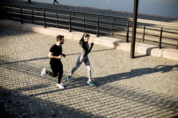 Healthy runners running in the city with cityscape background