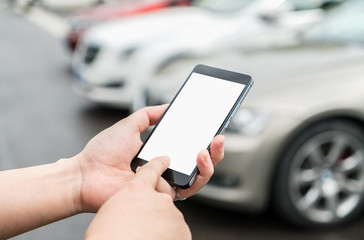 Man calls car with mobile phone APP in parking lot