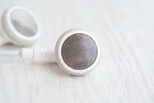 Headphones for Iphone white on white wooden desk close-up