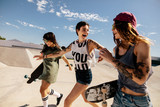 Fototapeta  - Urban girls enjoying at skate park