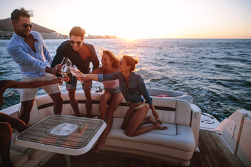 Wall Mural - Young people having a boat party at sunset