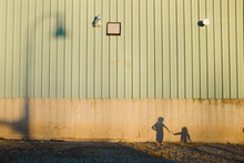 Shadows Of Two Girls Against Building