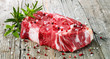 Raw Entrecote Beefsteak With Rosemary pepper On Wooden Table
