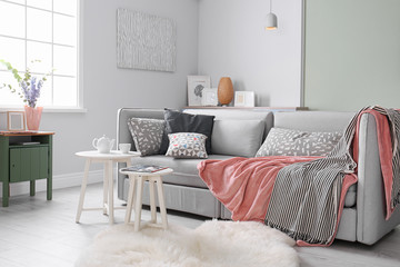 Poster - cozy living room interior with comfortable sofa and elegant table