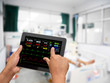 Doctor online checking patient monitor by use Tablet and wifi technology in intensive care unit (ICU), Tablet telehealth concept, remote medical doctor monitoring