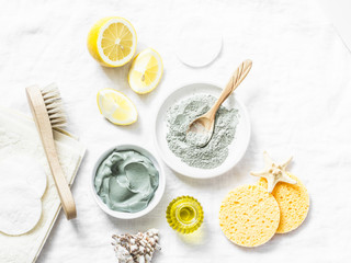 Wall Mural - homemade beauty facial mask. clay, lemon, oil, facial brush - beauty products ingredients on light b