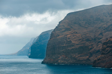 Wall Mural - View of the cloudy cliffs of Los Gigantes in Tenerife, Canary Islands, Spain