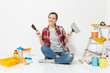 © ViDi Studio - Woman in casual clothes sitting on floor with putty knife, instruments for renovation apartment room isolated on white background. Wallpaper accessories for gluing painting tools. Repair home concept.