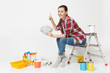 © ViDi Studio - Woman holds bundle of dollars, cash money, sits on ladder with instruments for renovation apartment isolated on white background. Wallpaper accessories for gluing painting tools. Repair home concept.
