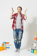 © ViDi Studio - Full length shocked sad woman in casual clothes standing near instruments for renovation apartment home isolated on white background. Wallpaper, accessories for gluing, painting tools. Repair concept.