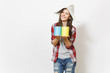 © ViDi Studio - Young smiling beautiful woman in casual clothes and newspaper hat holding paint tin cans isolated on white background. Instruments, accessories for renovation apartment room. Repair home concept.
