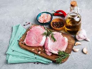 Fresh raw pork chops with spices and herbs