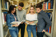 © Aleksandr - Group of student want to find some helpful literature to preparing for university exam