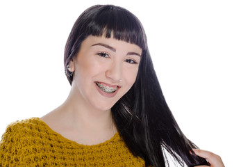 Young woman wearing braces on white background