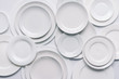 white plates composition on white background