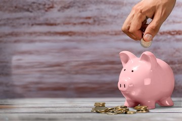 Sticker - Hand putting a coin in piggy bank