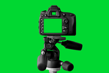 The Dslr camera with green screen on the tripod isolated on green background. The chromakey. Green screen.