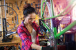 Young woman working in a bicycle repair shop
