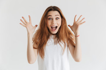 Wall Mural - Surprised happy woman in t-shirt looking at the camera