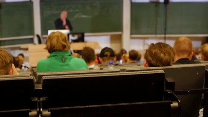 professor or teacher delivers a lecture college to a large audience of students