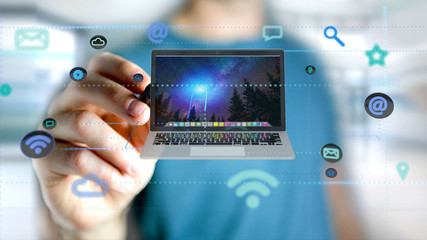 Poster - Businessman holding a Computer surrounding by app and social icon - 3d render