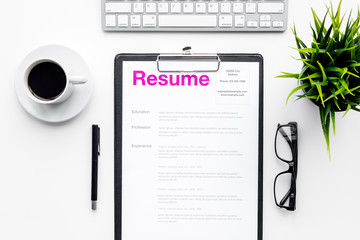 Poster - Create resume. Resume on white work desk with coffee, glasses, keyboard top view