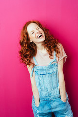 Wall Mural - Young laughing woman wearing overalls